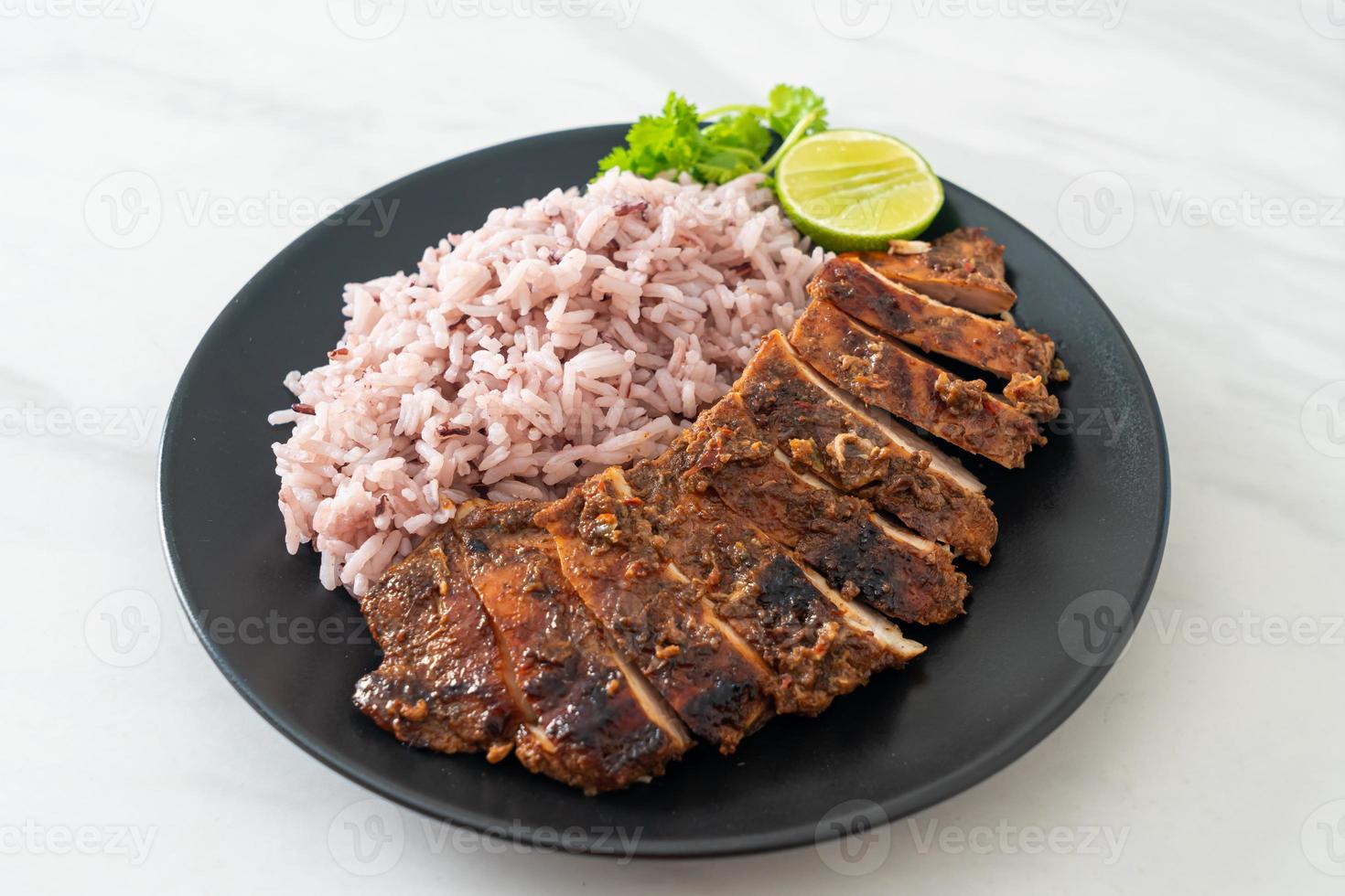 Spicy grilled Jamaican jerk chicken with rice - Jamaican food style photo