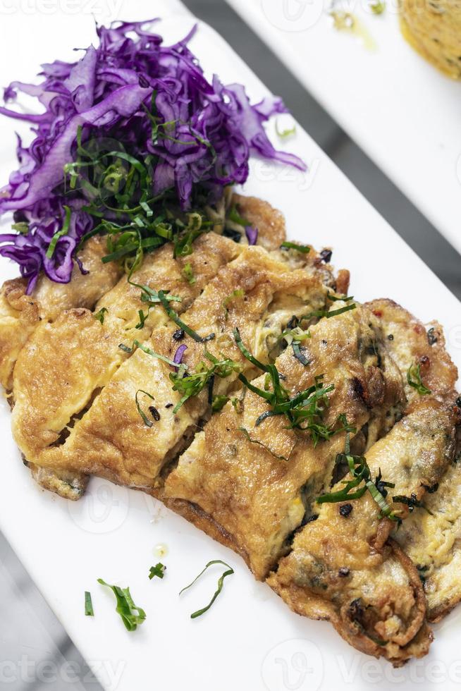 Spicy chorizo and mushroom omelette with red cabbage salad tapas snack in Lisbon restaurant photo