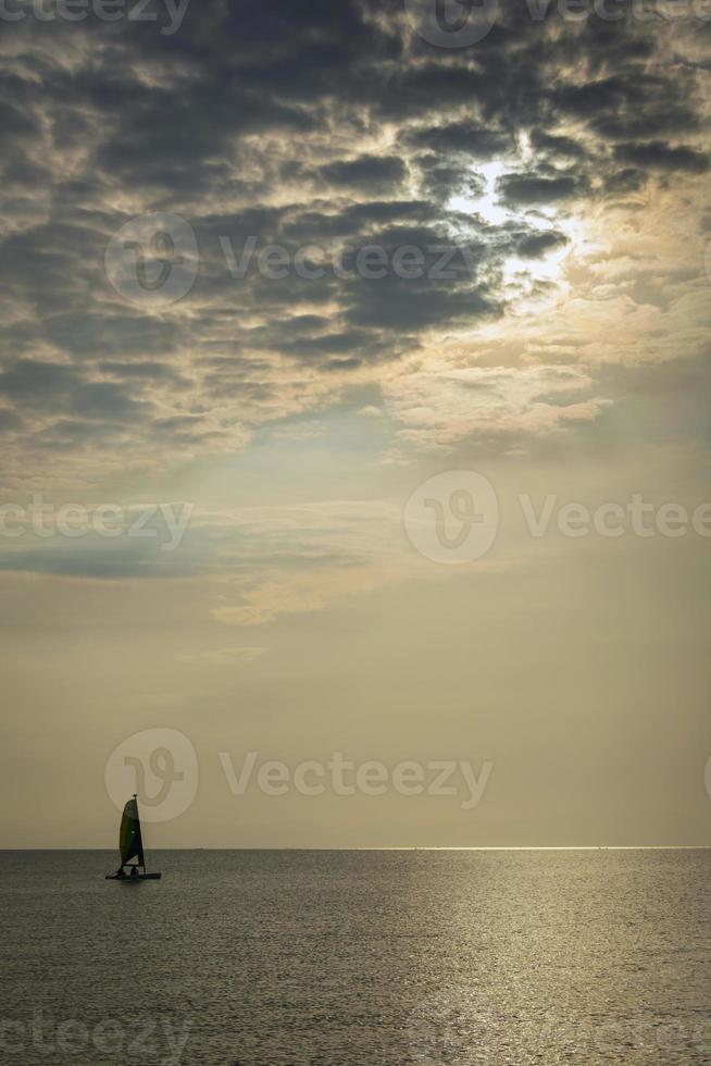 Sailing boat at sea during sunset in Phuket coast of Thailand photo