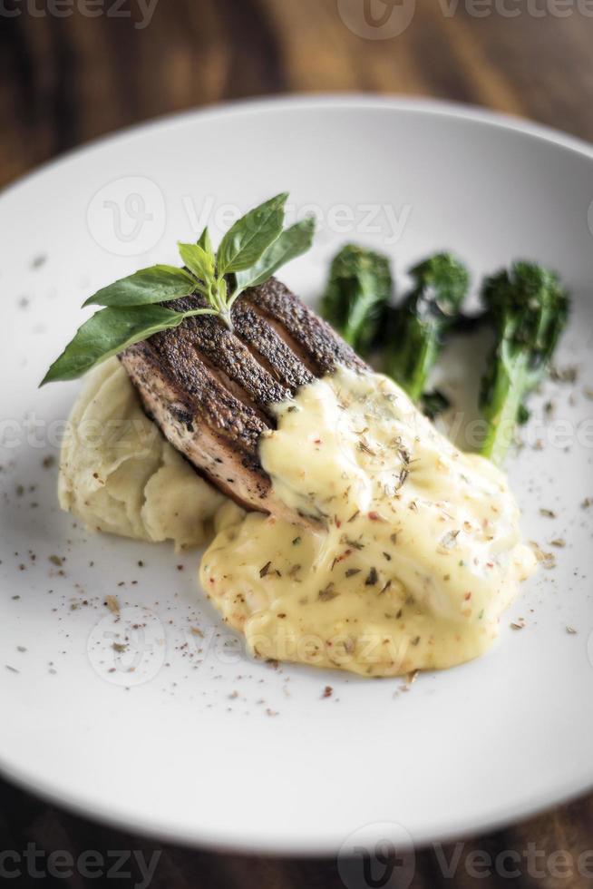 Grilled salmon fish fillet with mashed potato and dijon mustard cream sauce photo