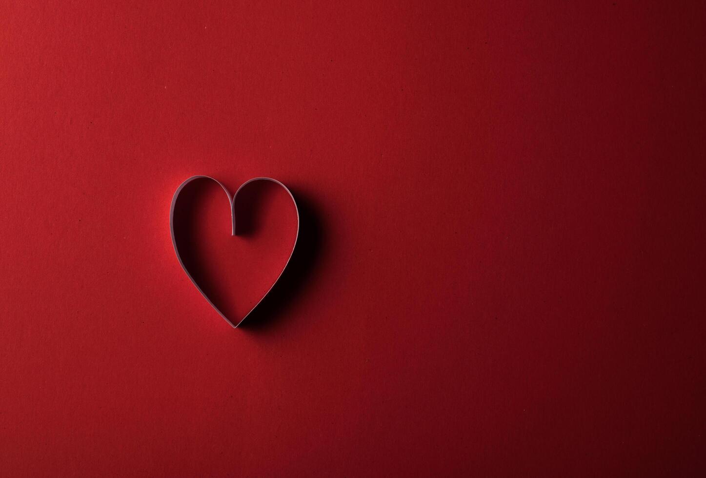 Red Hearts paper on Red background photo