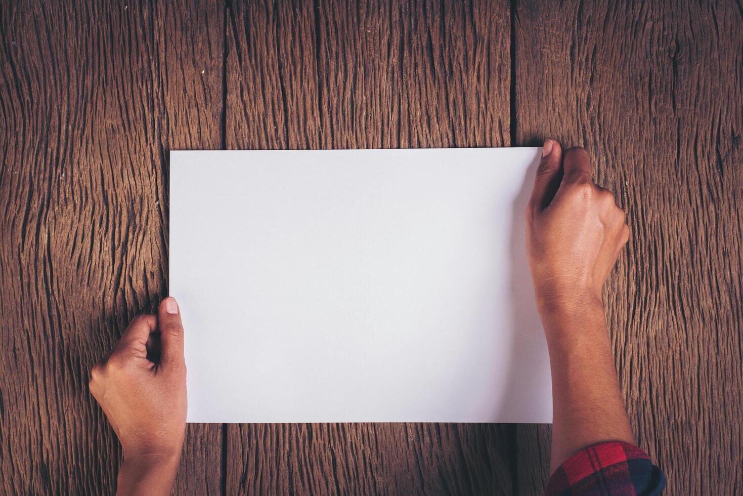 Top view Hand with blank white paper. photo