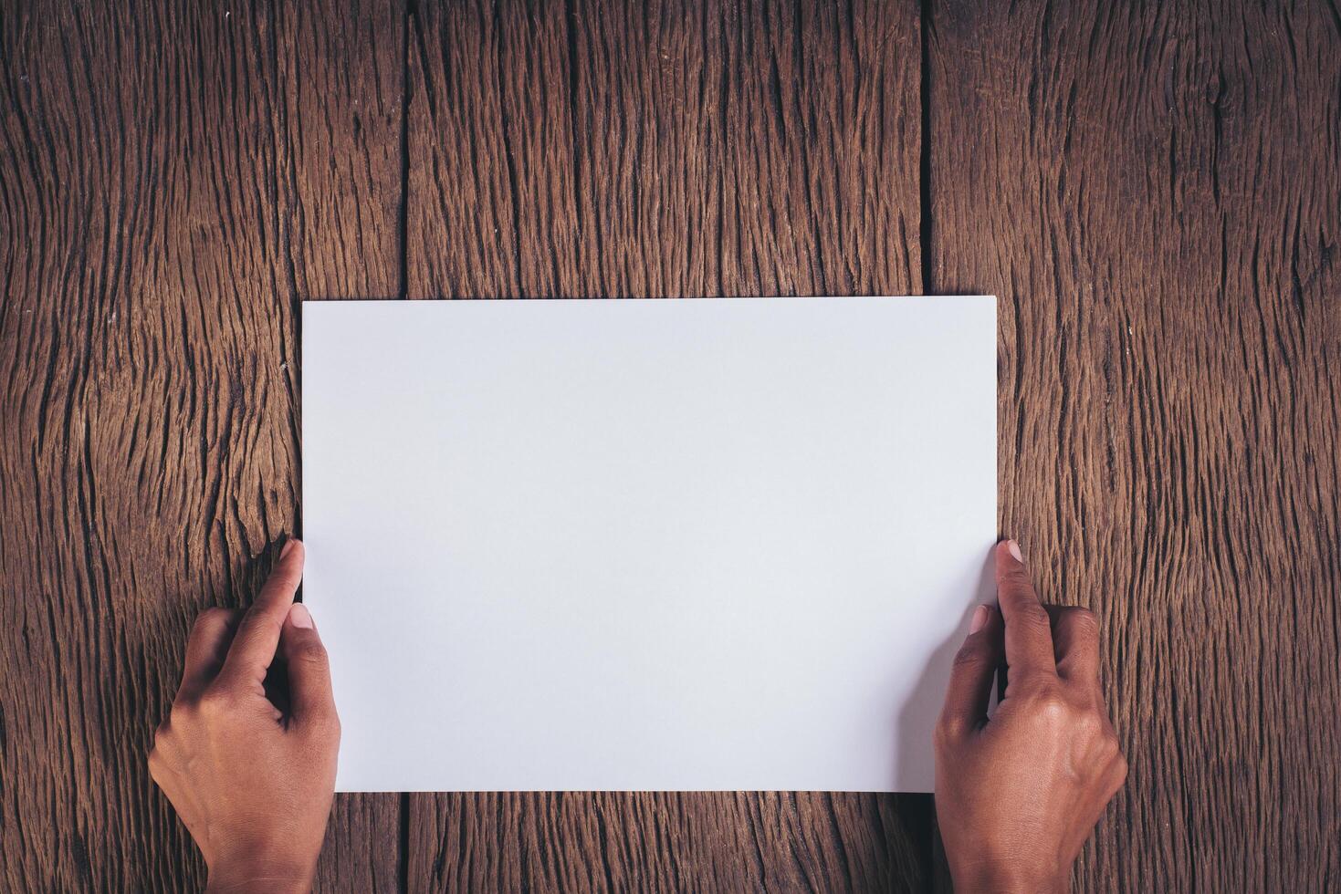 Top view Hand with blank white paper. photo
