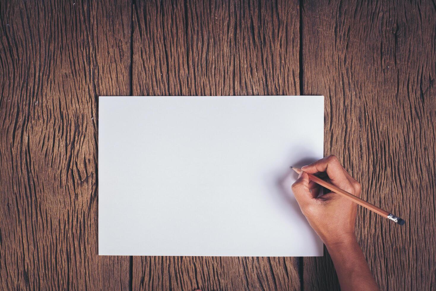 Top view Hand with blank white paper. photo