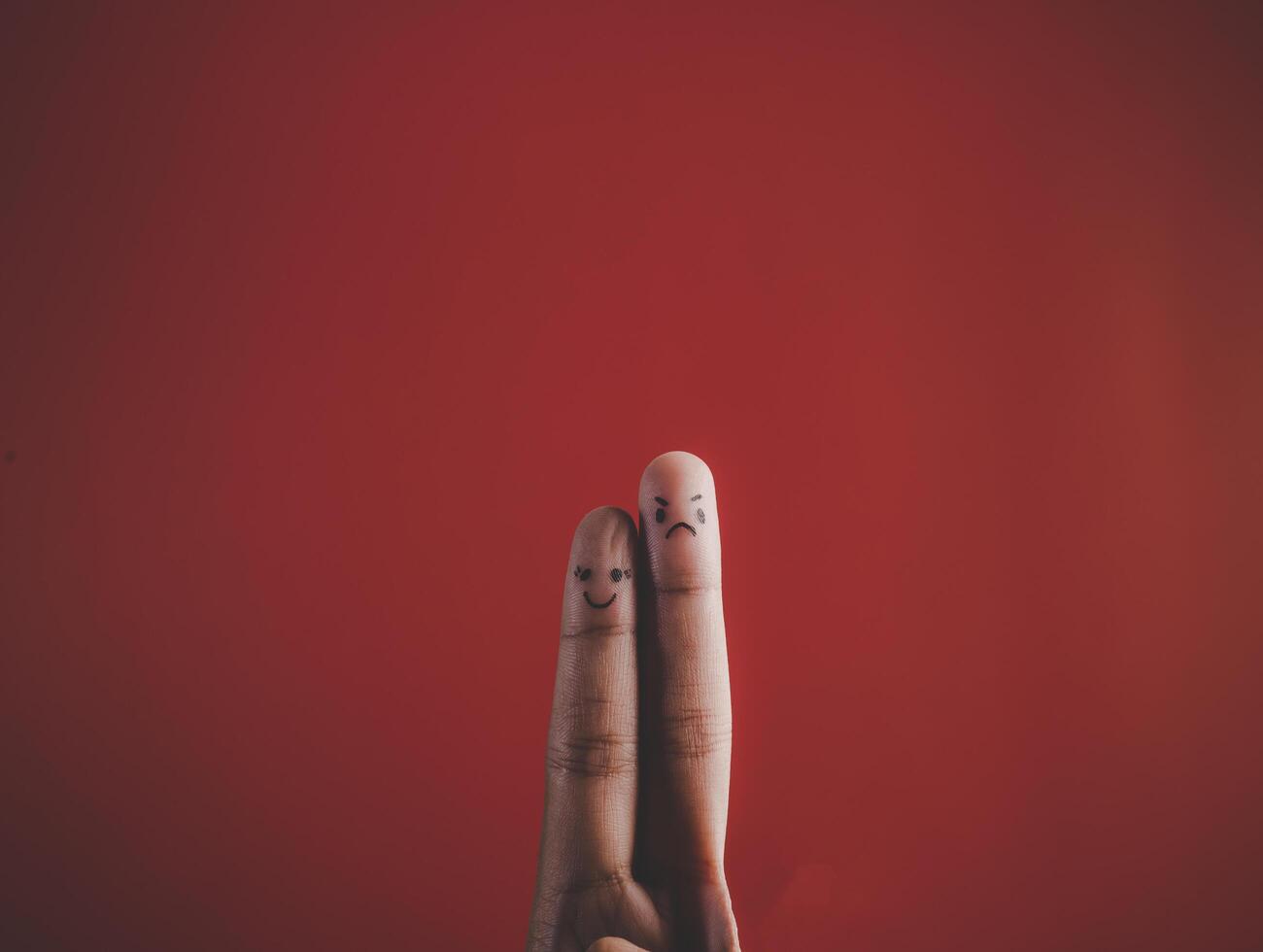 Finger with emotion on red background. photo