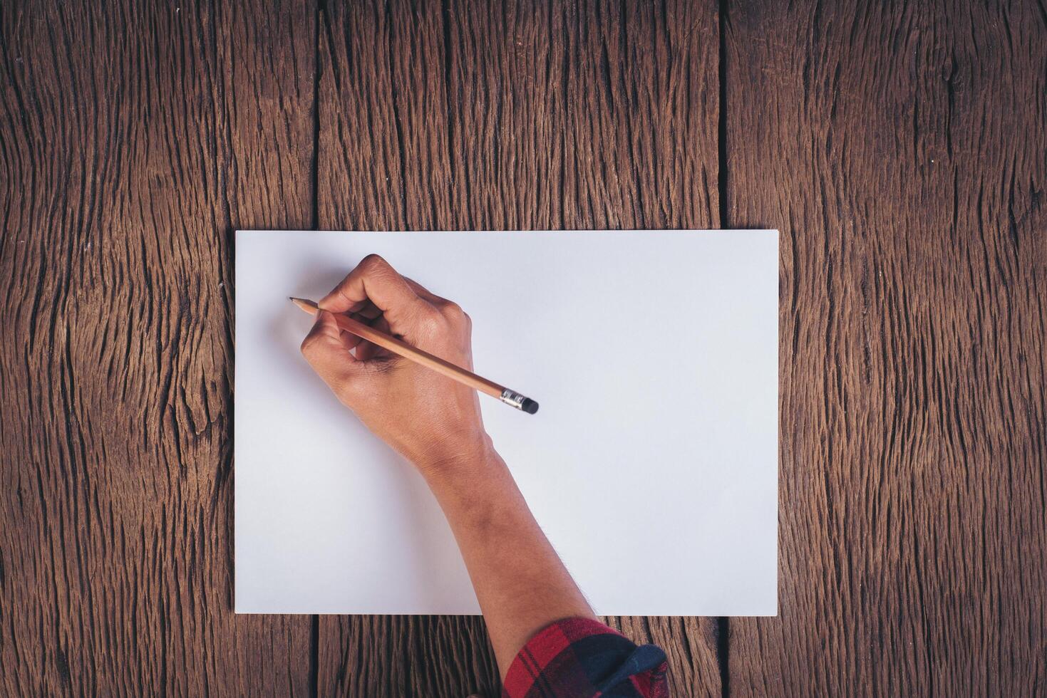 Top view Hand with blank white paper. photo