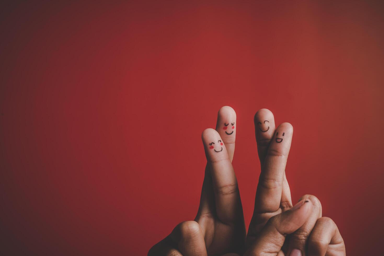 Finger with emotion on red background. photo