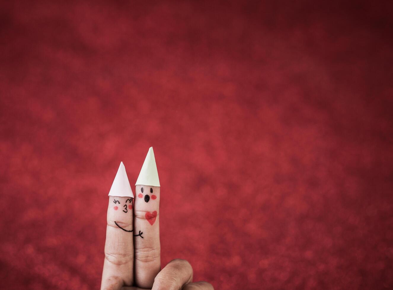 Finger with emotion on red background. photo