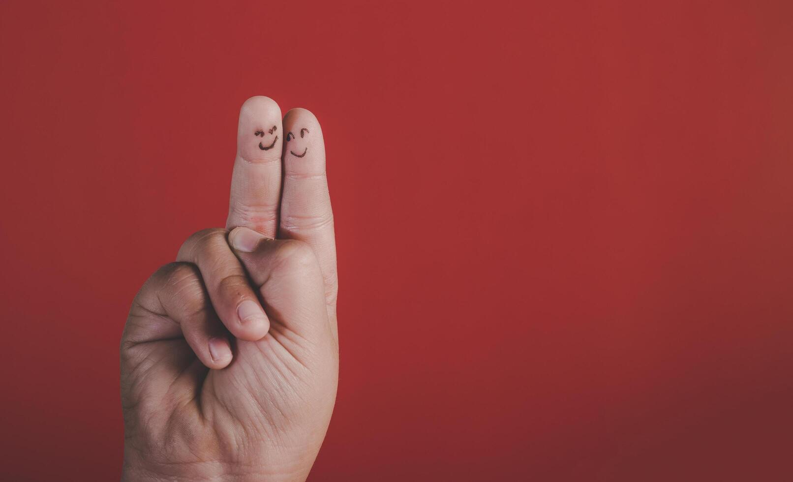 Finger with emotion on red background. photo