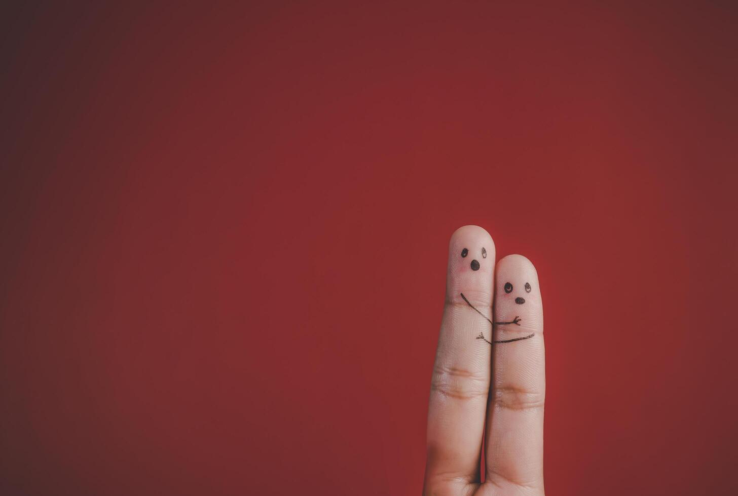 Finger with emotion on red background. photo