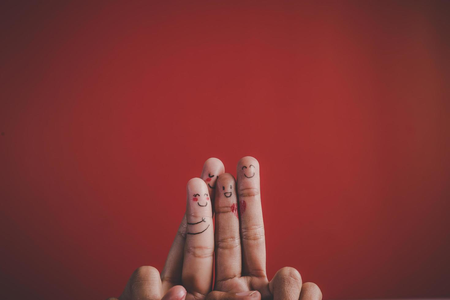 Finger with emotion on red background. photo
