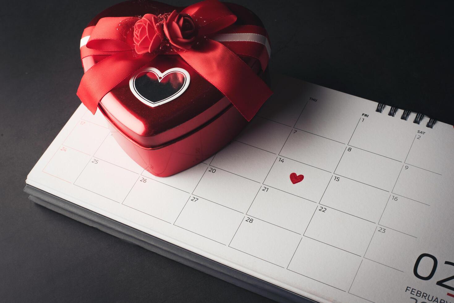 Red Heart in February 14 on the calendar with Heart shaped gift box. photo