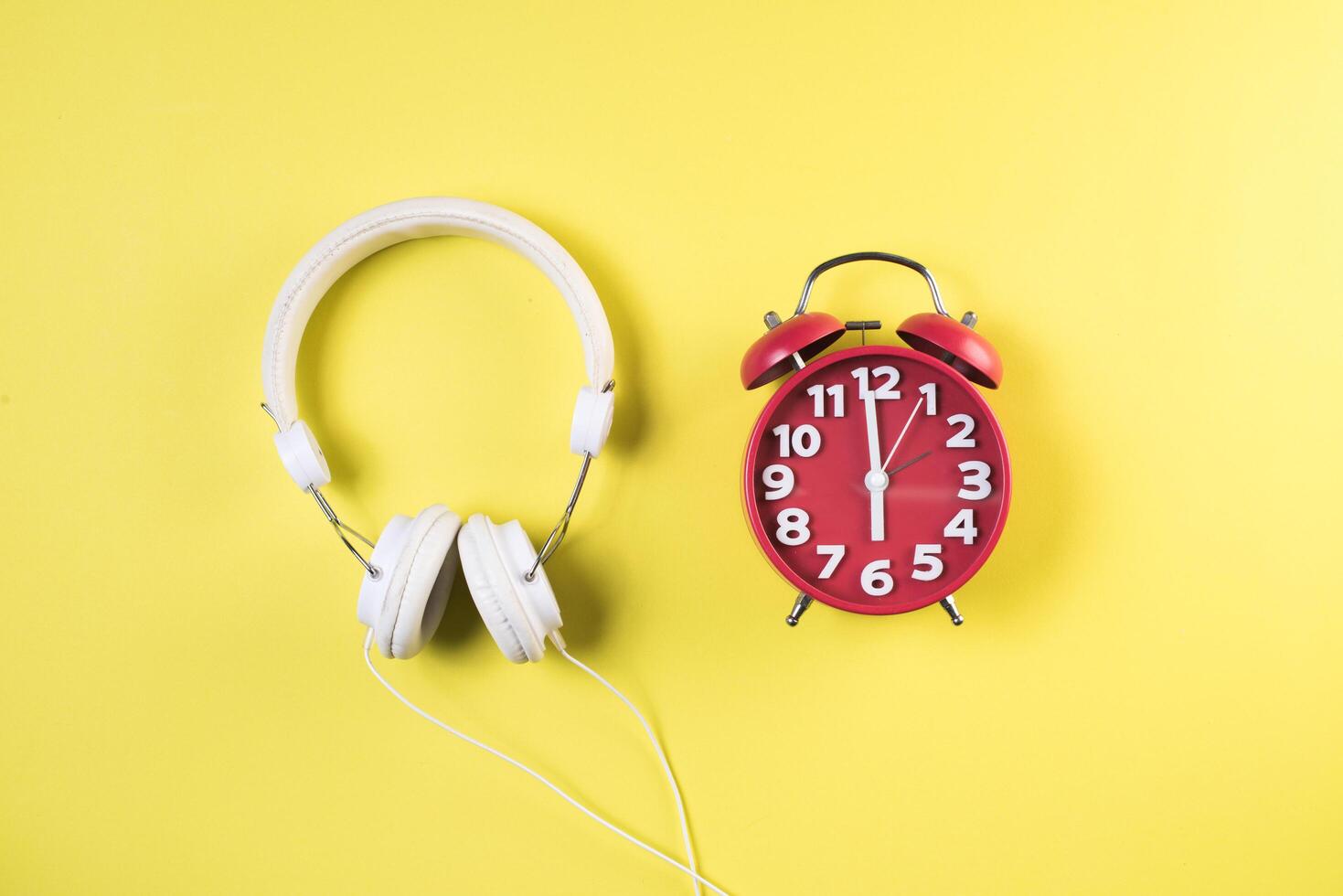 Top view red alarm clock with headphone. photo