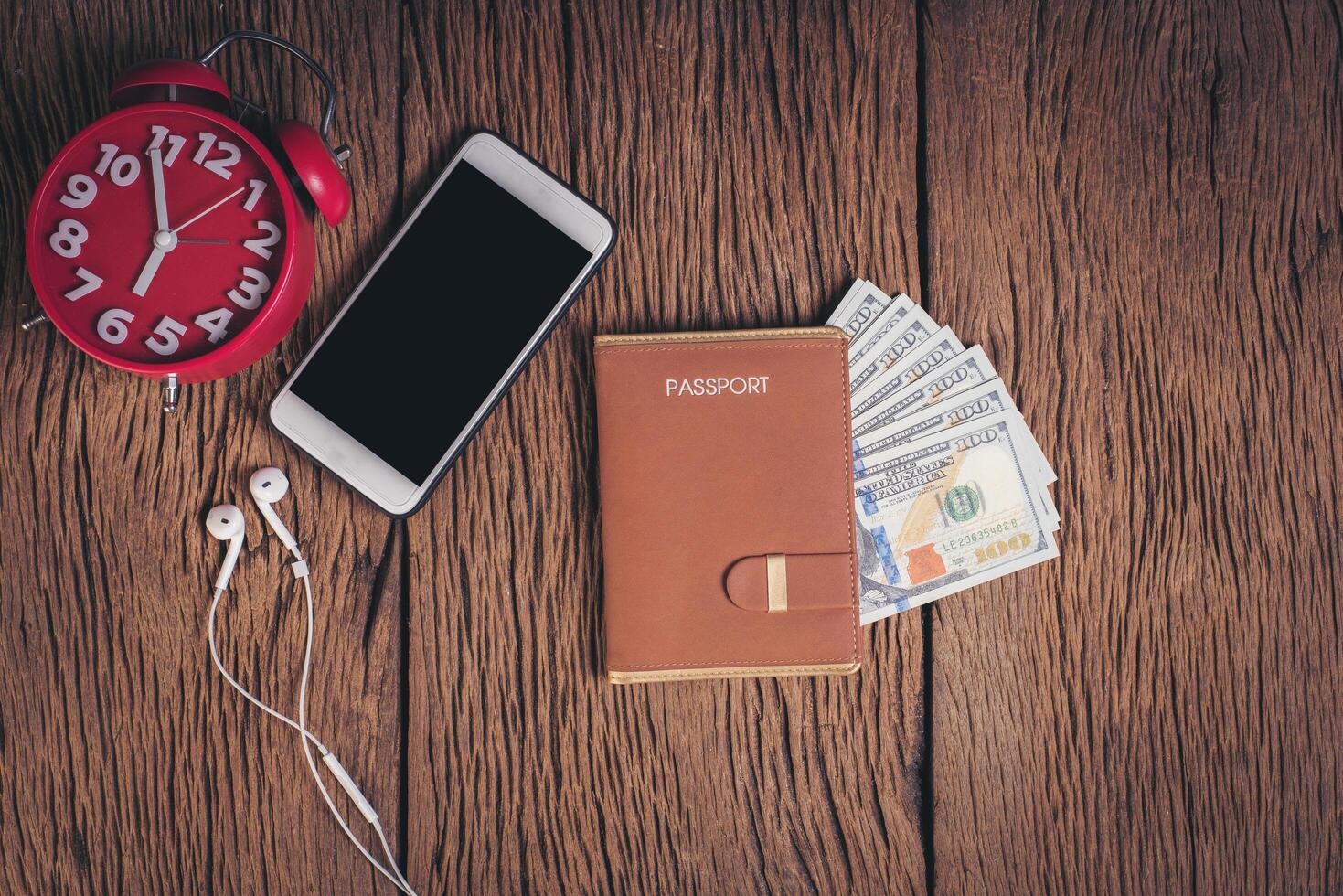 Top view passport with money on wood background, tourism concept. photo