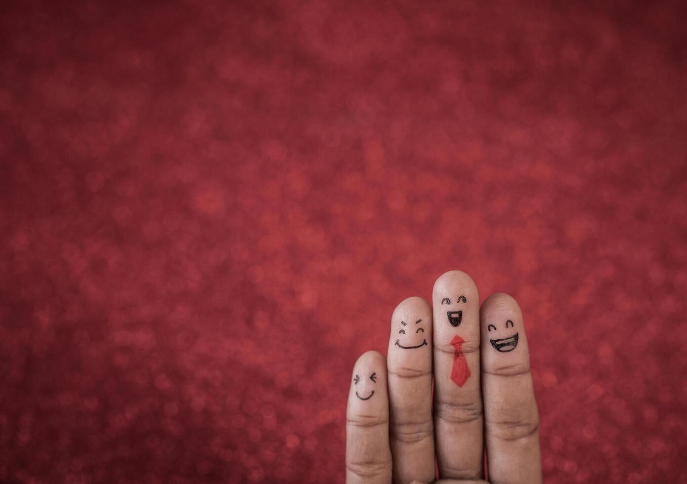 Finger with emotion on red background. photo