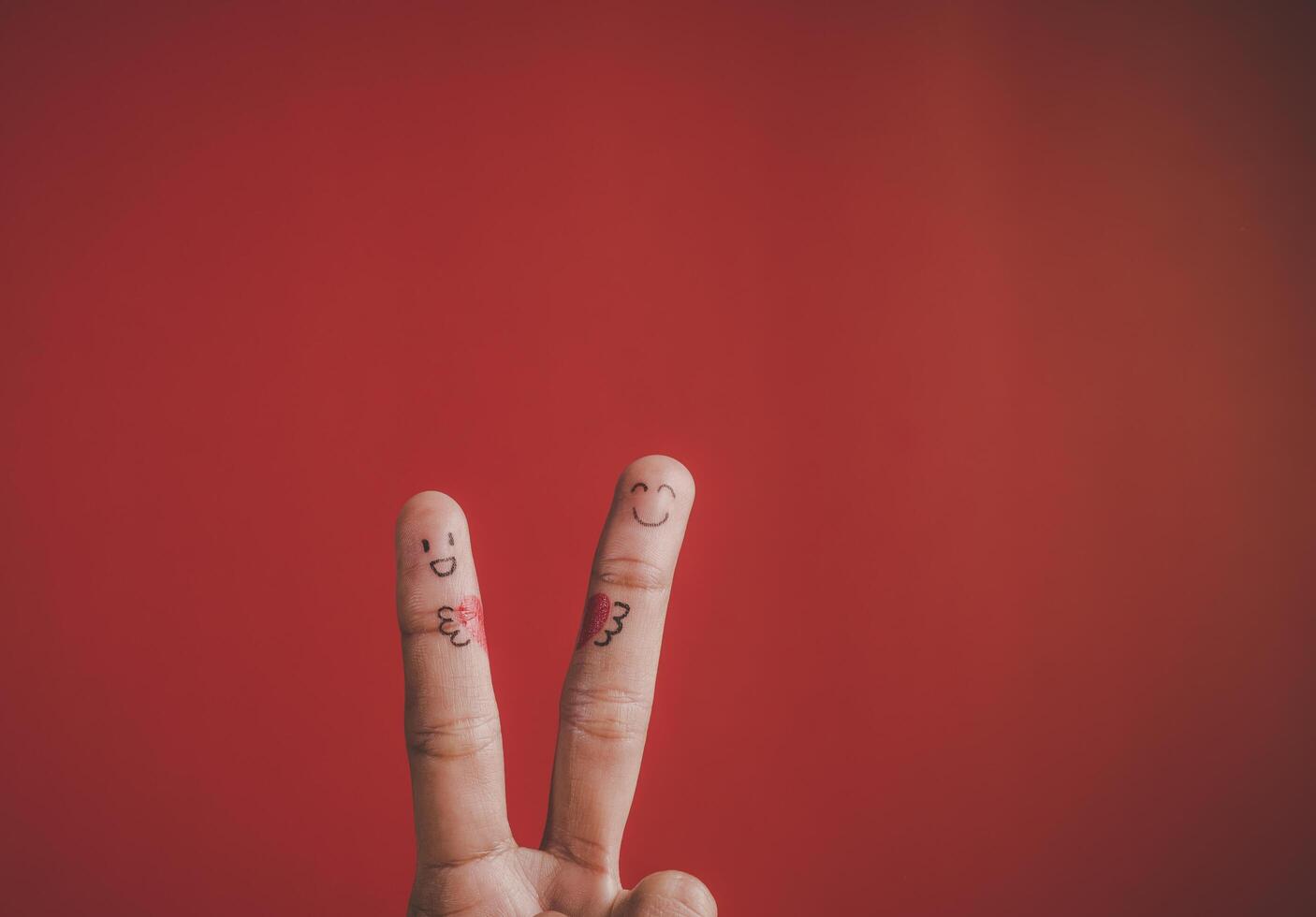 Finger with emotion on red background. photo