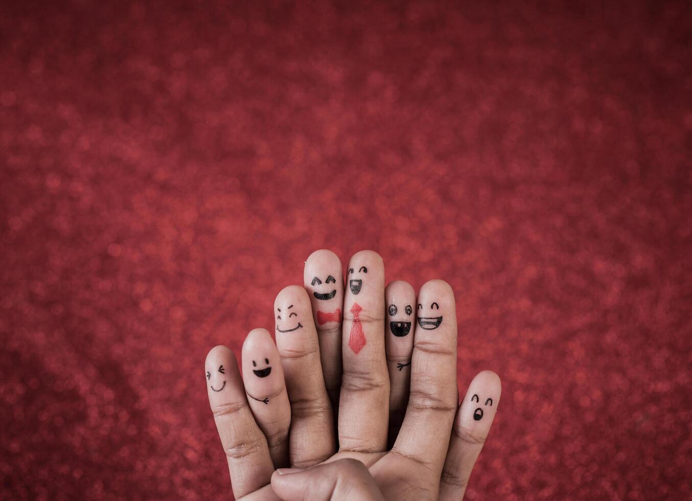 Finger with emotion on red background. photo