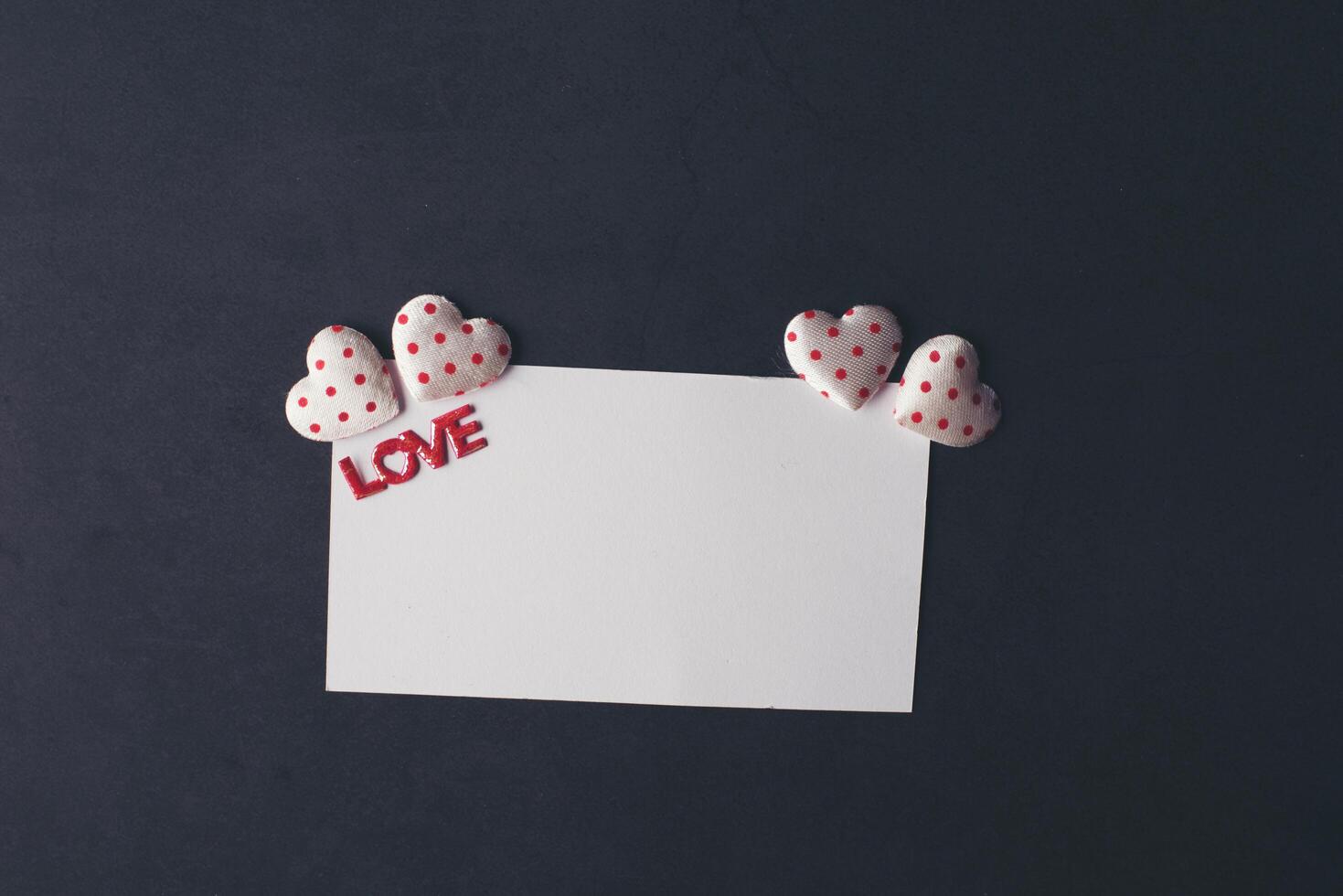 Heart and blank with note card on Red background. photo