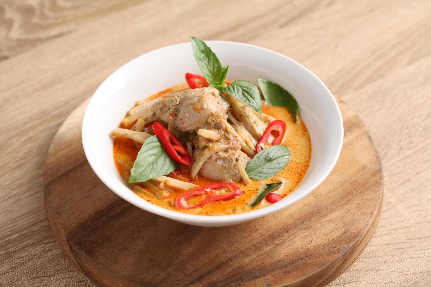 Thai chicken and bamboo shoot curry in ceramic bowl photo