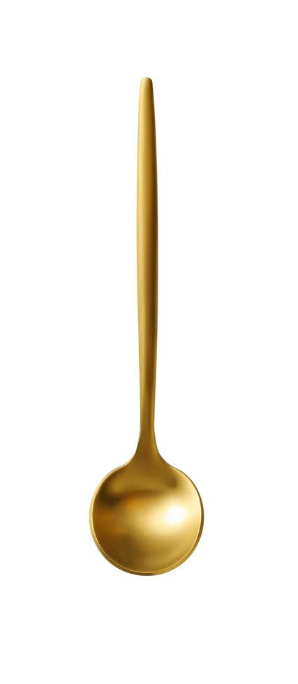 Golden tea spoon on a white background photo