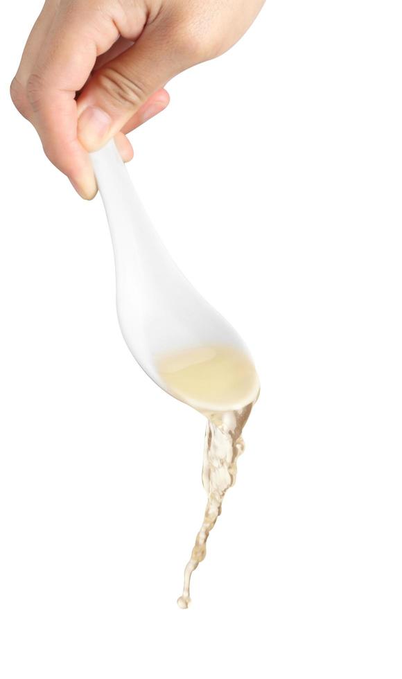 Chef pouring noodle soup on white background photo