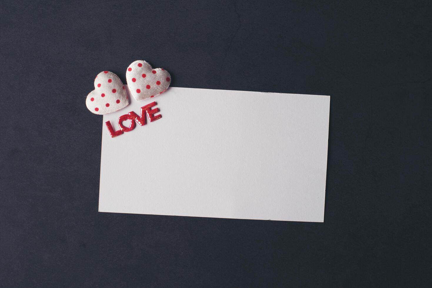 Heart and blank with note card on Red background. photo