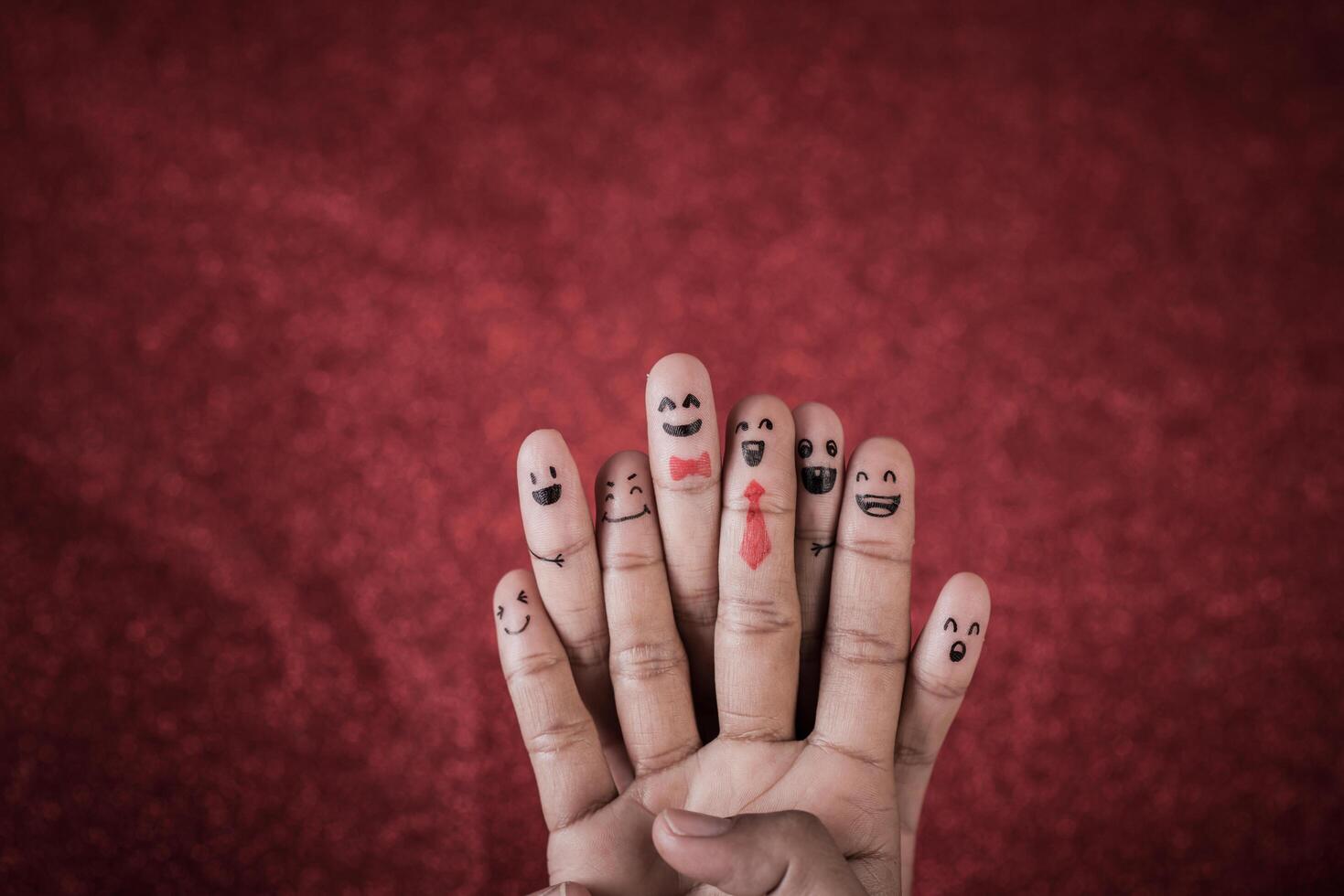 Finger with emotion on red background. photo