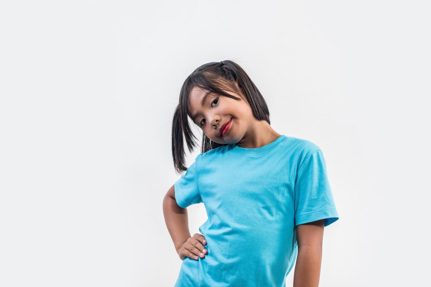 Portrait of Funny little girl acting in studio shot. photo