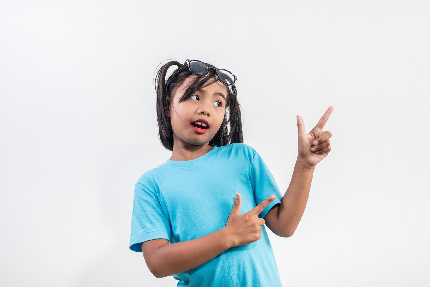 Portrait of Funny little girl acting in studio shot. photo