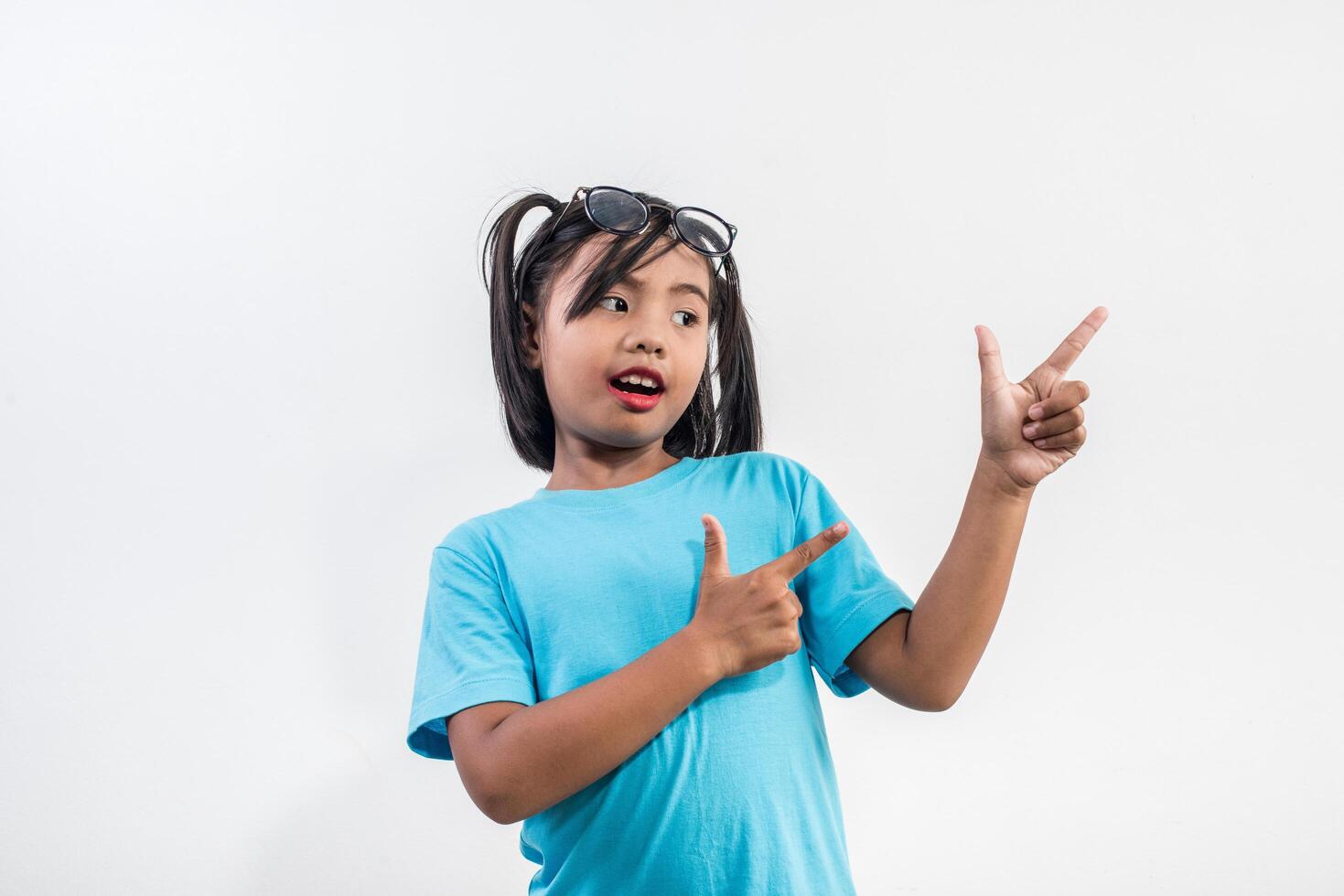 Portrait of Funny little girl acting in studio shot. photo