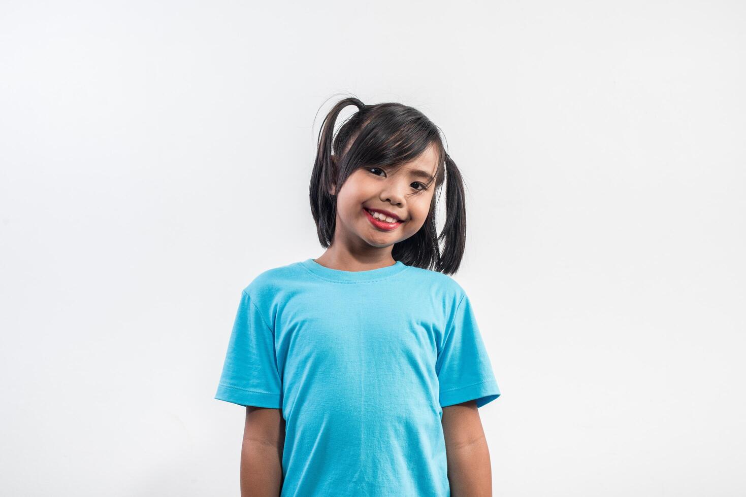 Portrait of Funny little girl acting in studio shot. photo