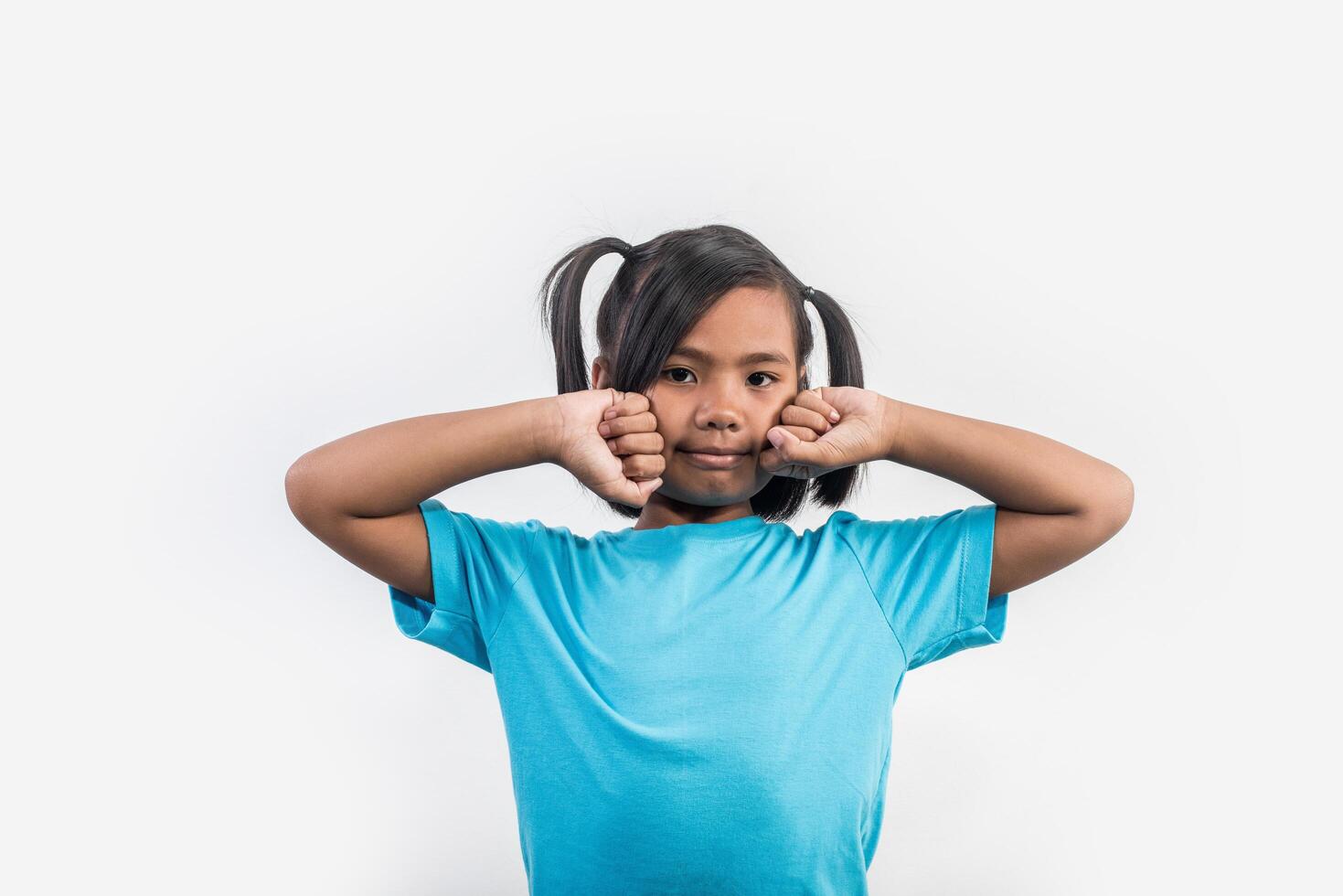 Portrait of Funny little girl acting in studio shot. photo