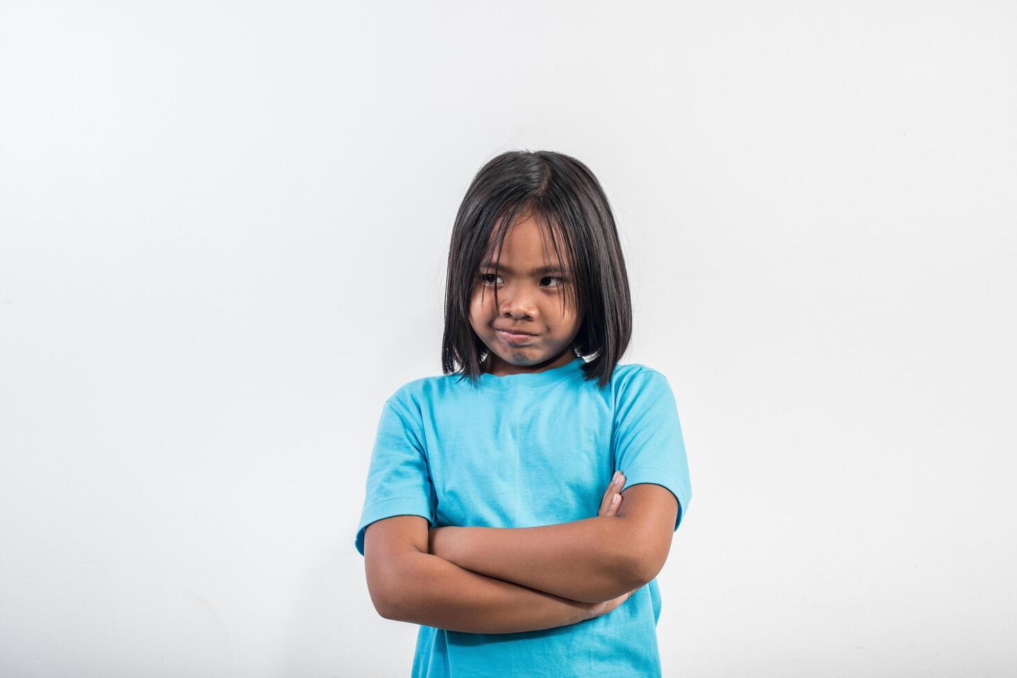 Little girl feel angry in studio shot. photo