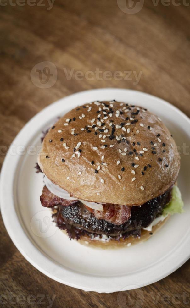 Australian organic beef burger with bacon on wood table background photo