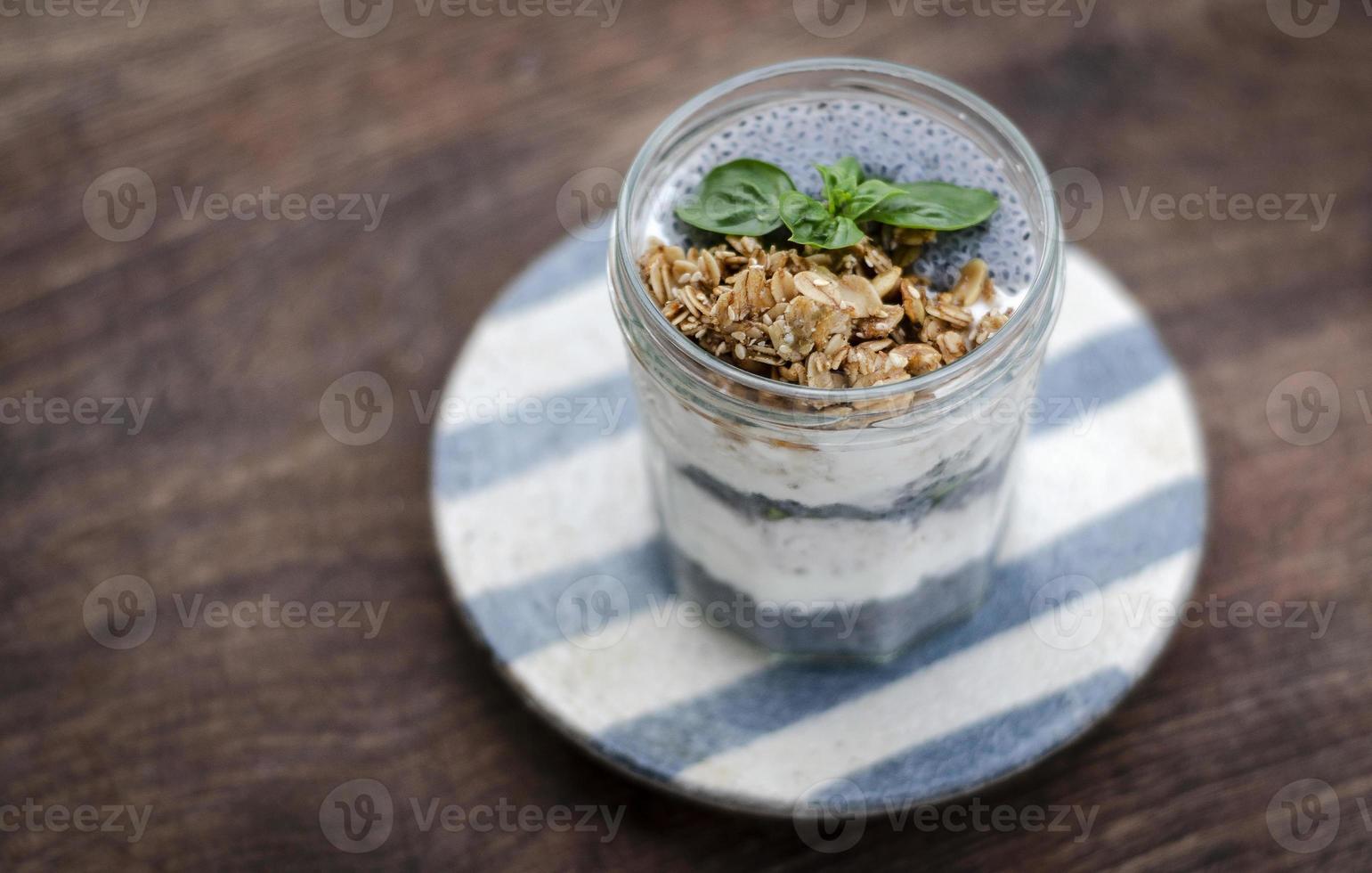 Homemade healthy rustic yogurt and granola with basil seeds breakfast snack cup photo