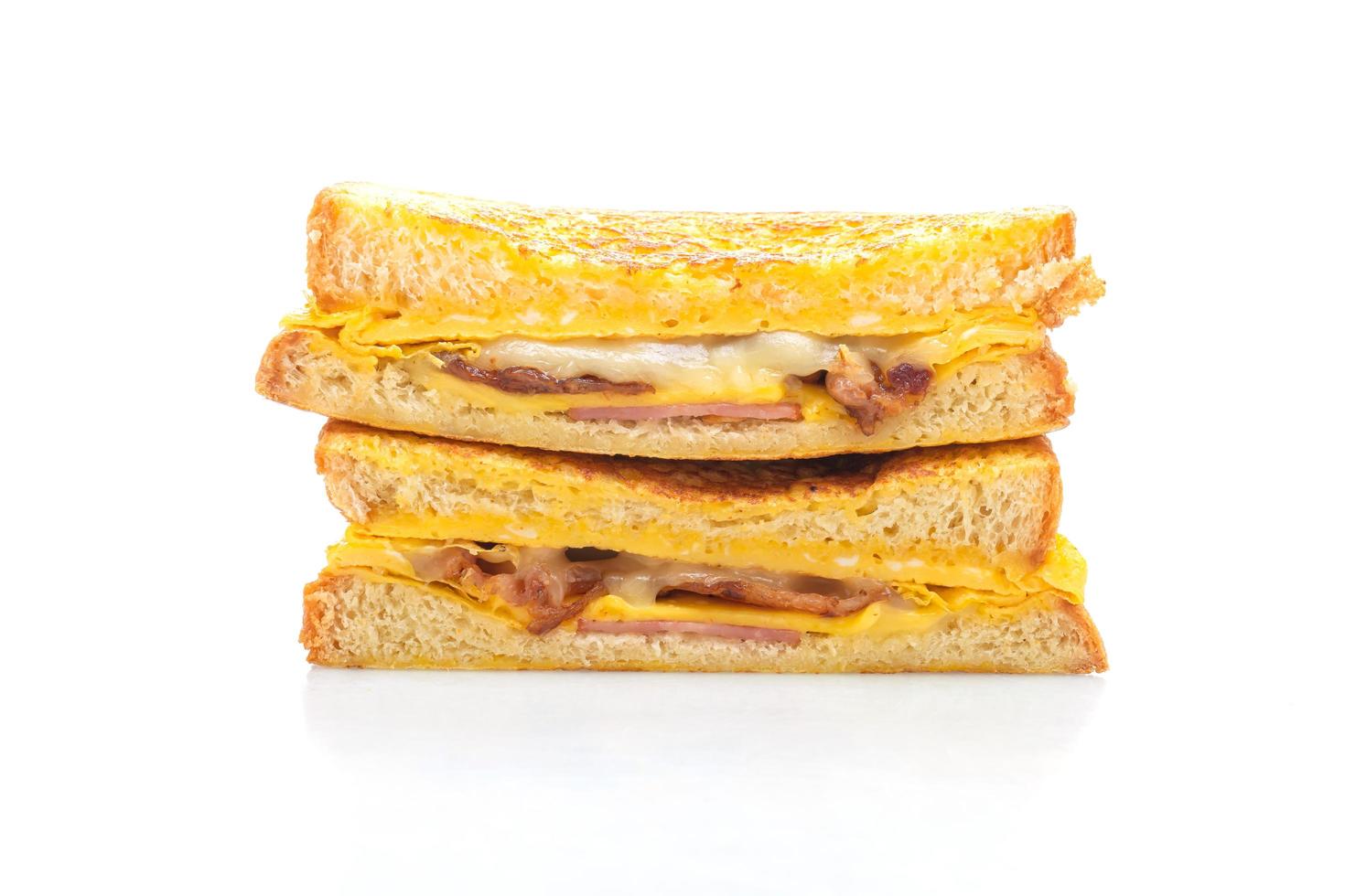 French toast ham, bacon, and cheese sandwich with egg isolated on white background photo