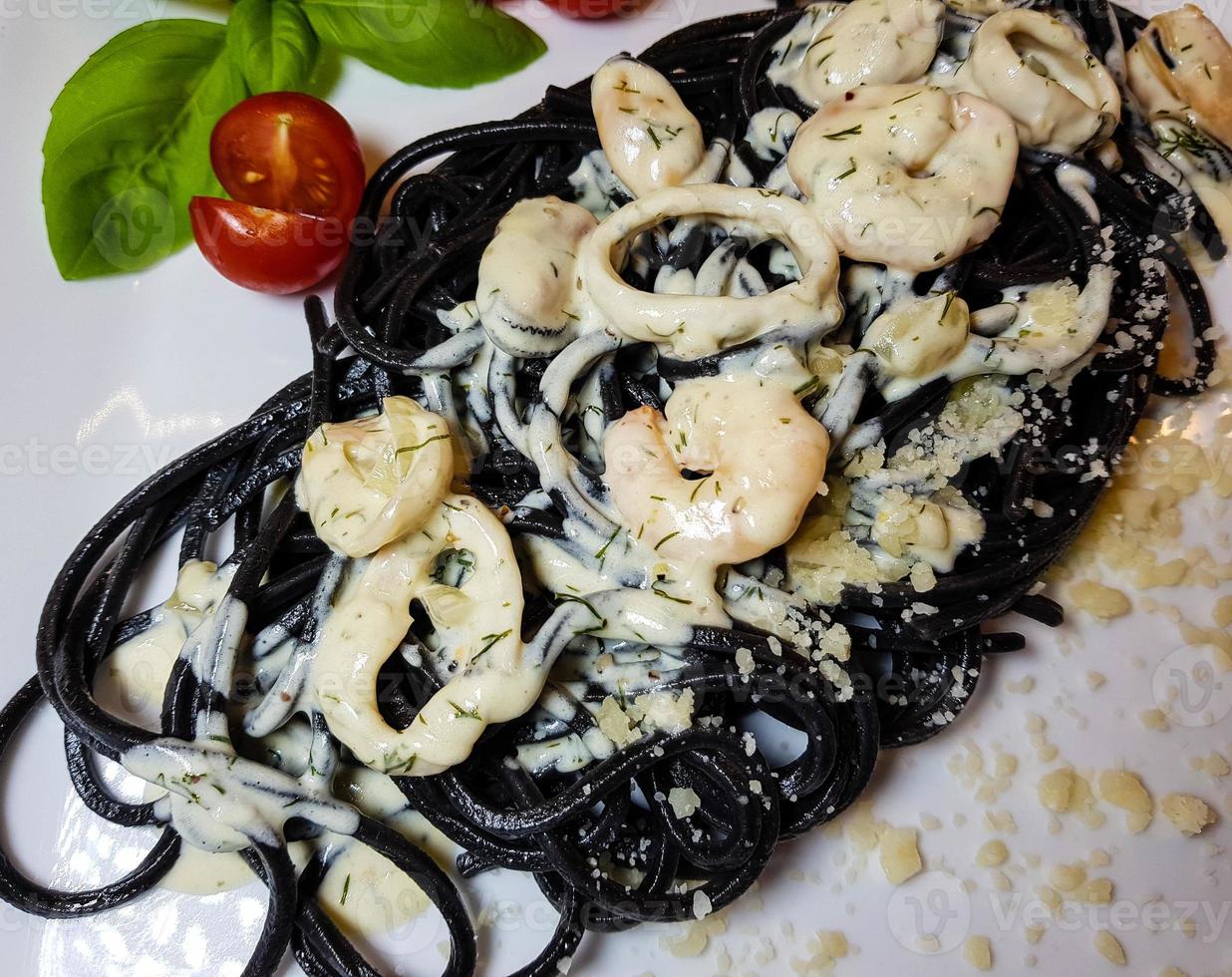 Spaghetti Rigate - black pasta with mixed seafood photo