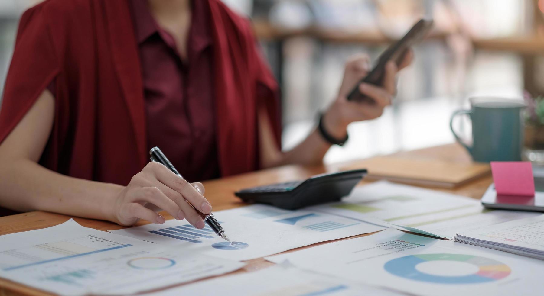 Business woman working at office with laptop and documents on his desk photo