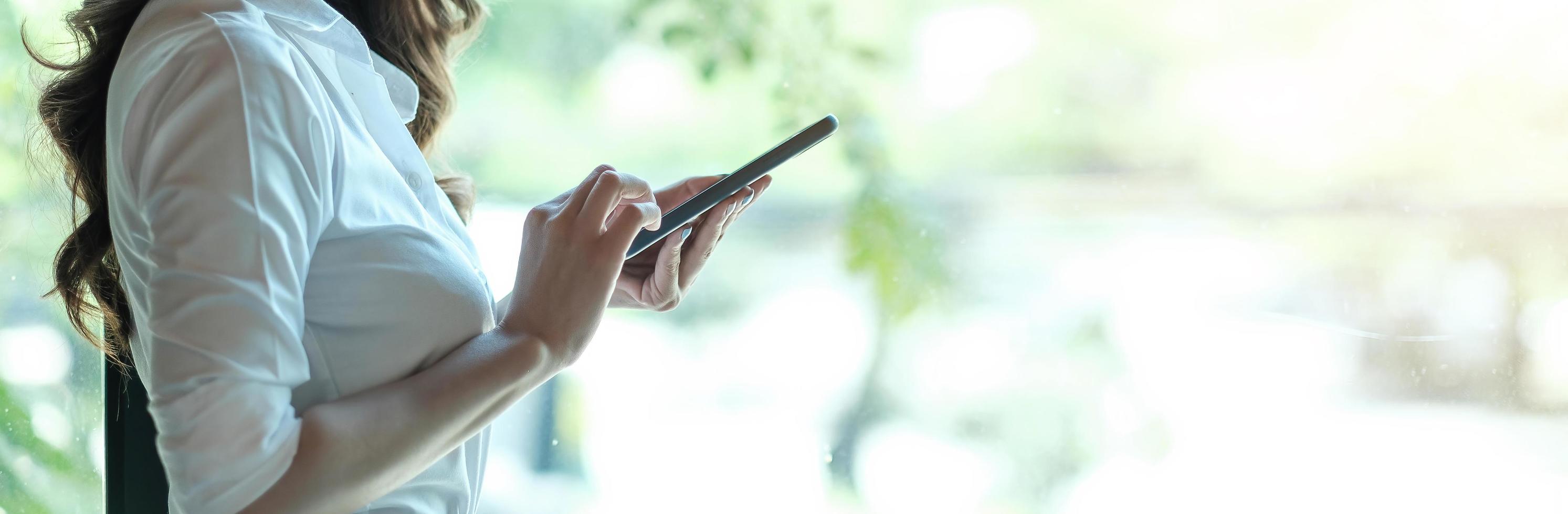 Close up hand of woman using smartphone, texting text message photo