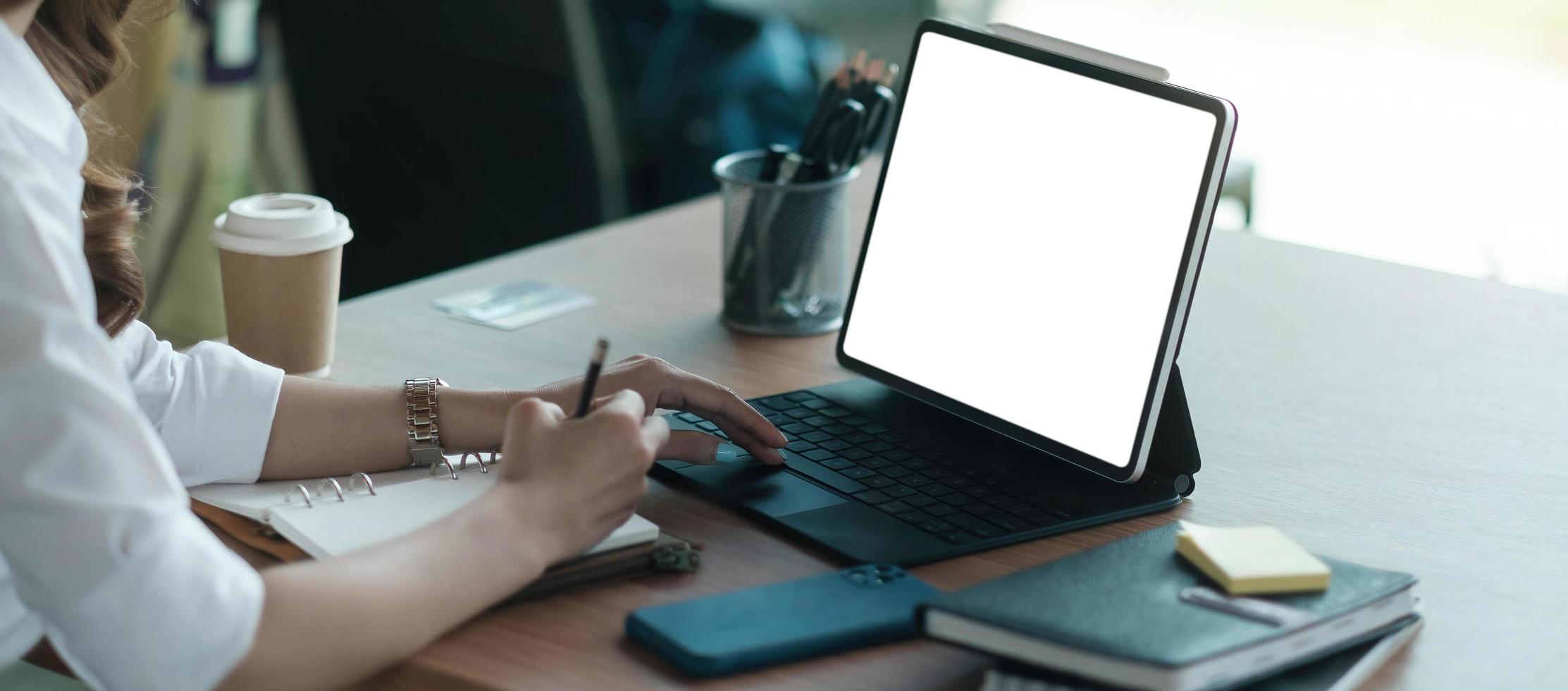 Close up hand of business woman typing keyboard on digital tablet photo