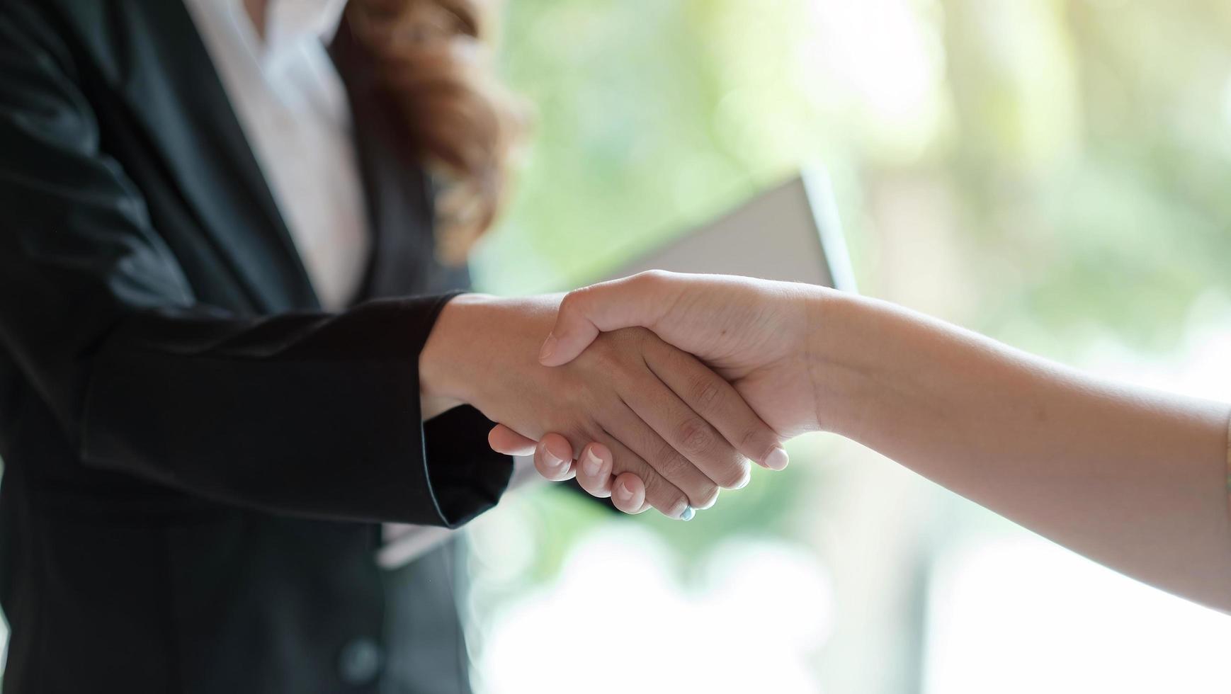 Close up of Business people shaking hands, finishing up meeting photo