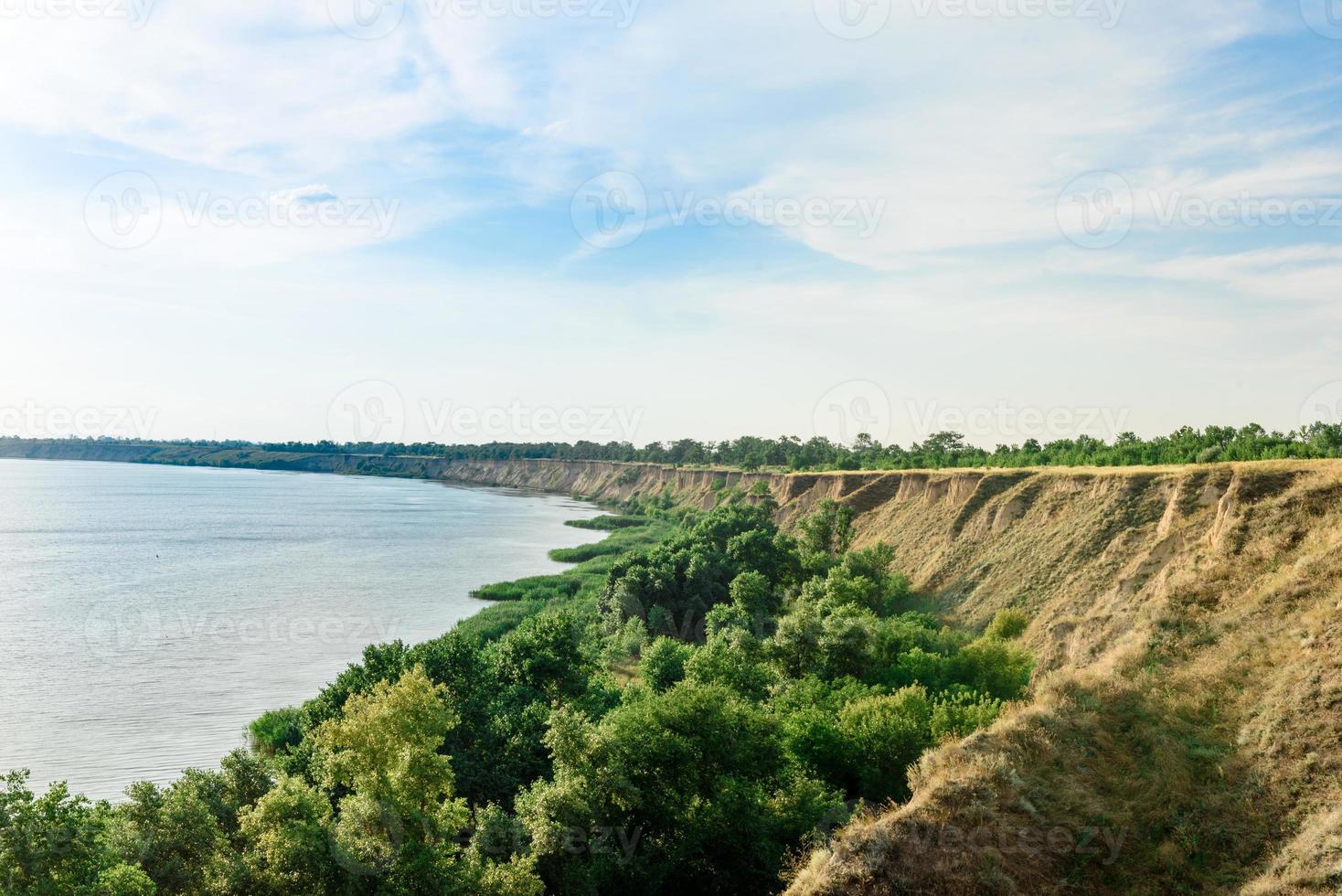 Picturesque slope of the sea coast on a warm summer day photo