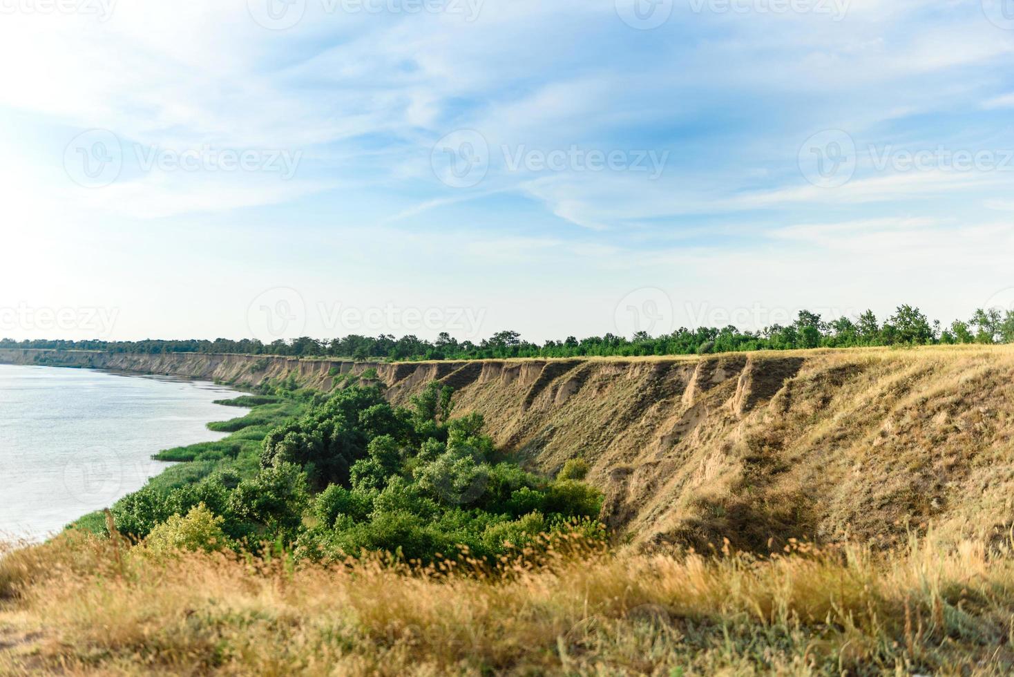 Picturesque slope of the sea coast on a warm summer day photo