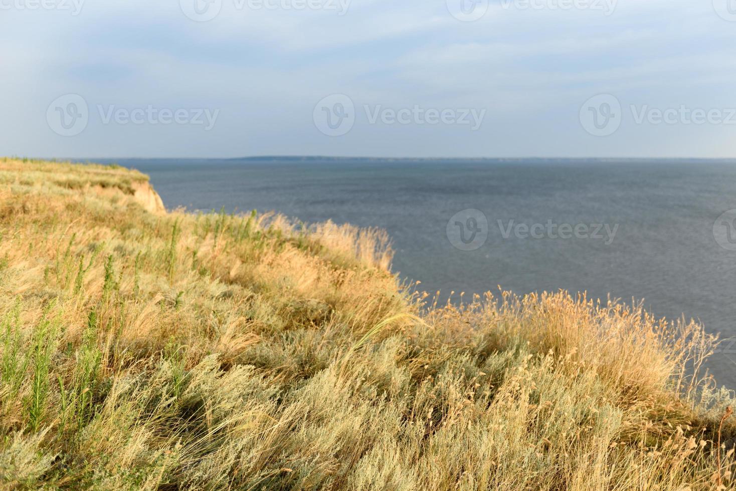 Picturesque slope of the sea coast on a warm summer day photo