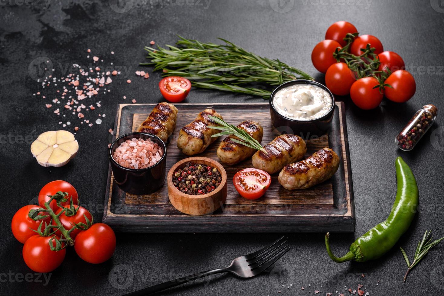 Grilled sausage with the addition of herbs and vegetables photo