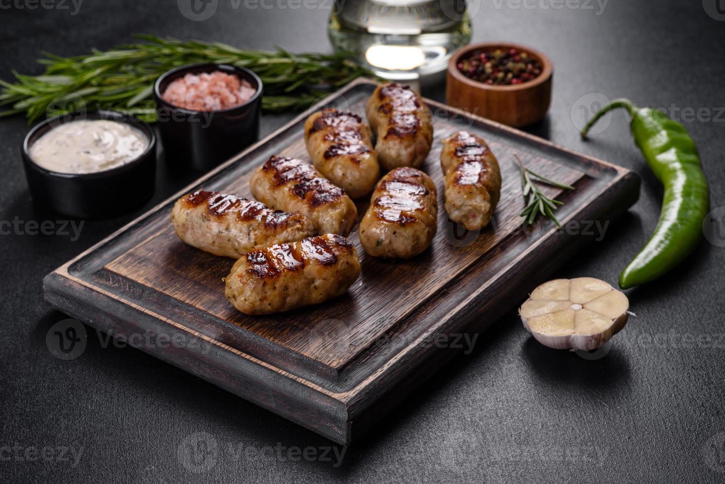 Grilled sausage with the addition of herbs and vegetables photo