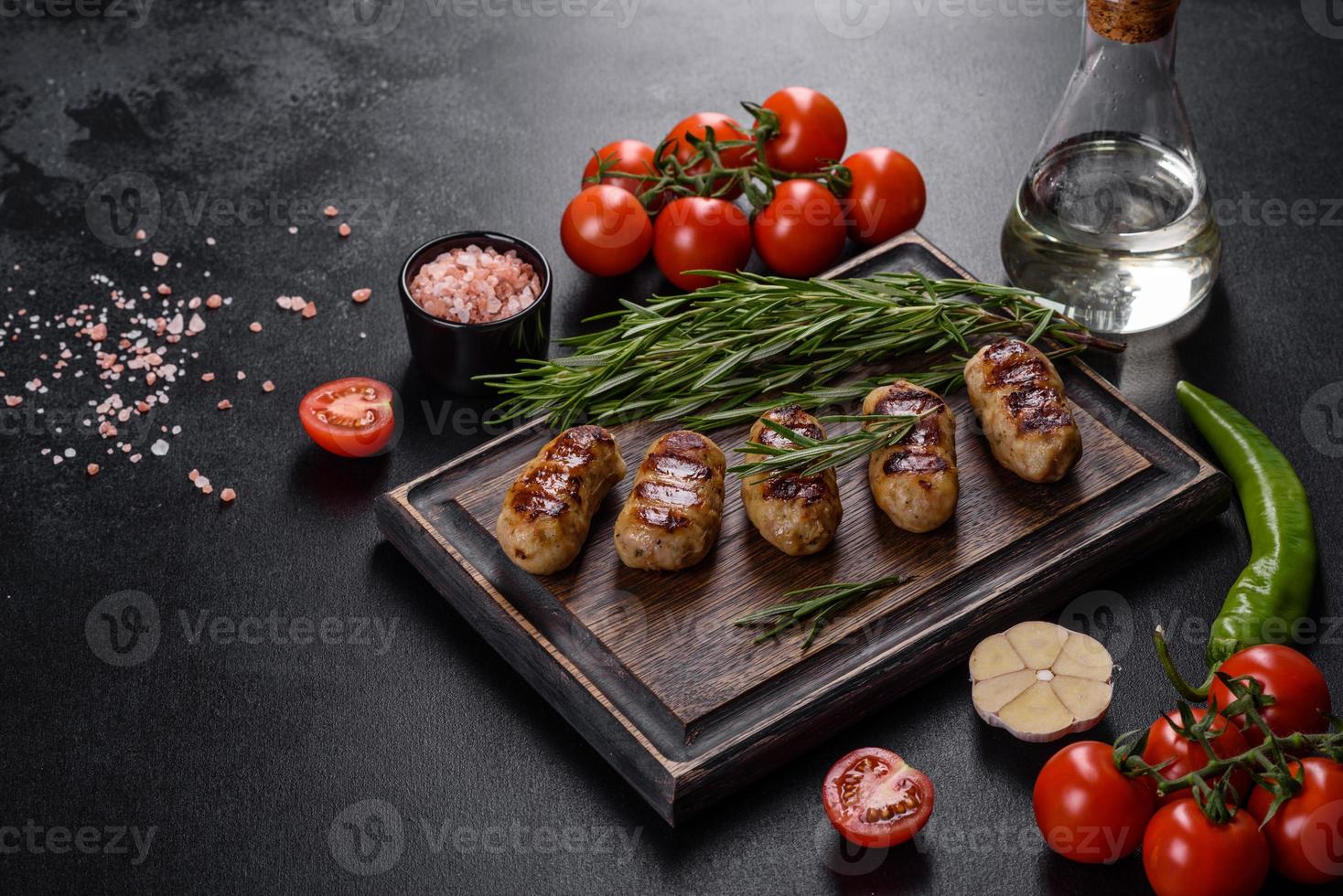 Grilled sausage with the addition of herbs and vegetables photo