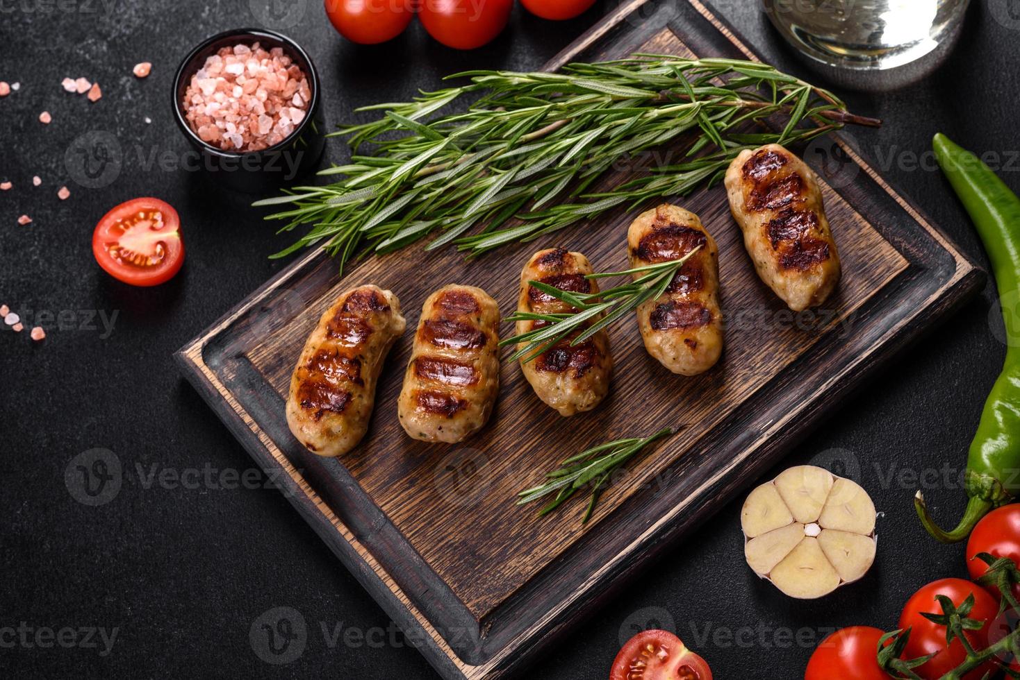 Grilled sausage with the addition of herbs and vegetables photo