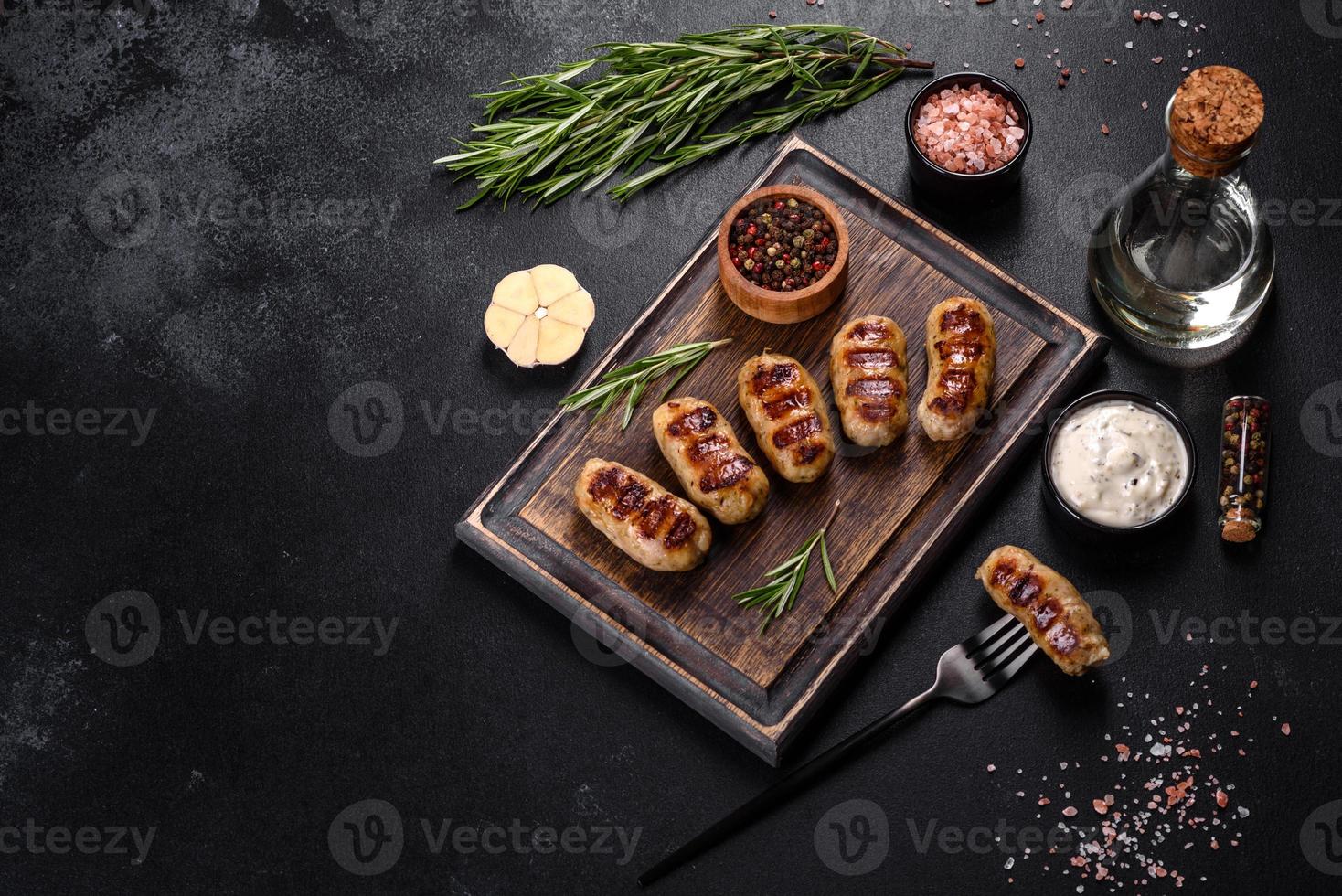 Grilled sausage with the addition of herbs and vegetables photo