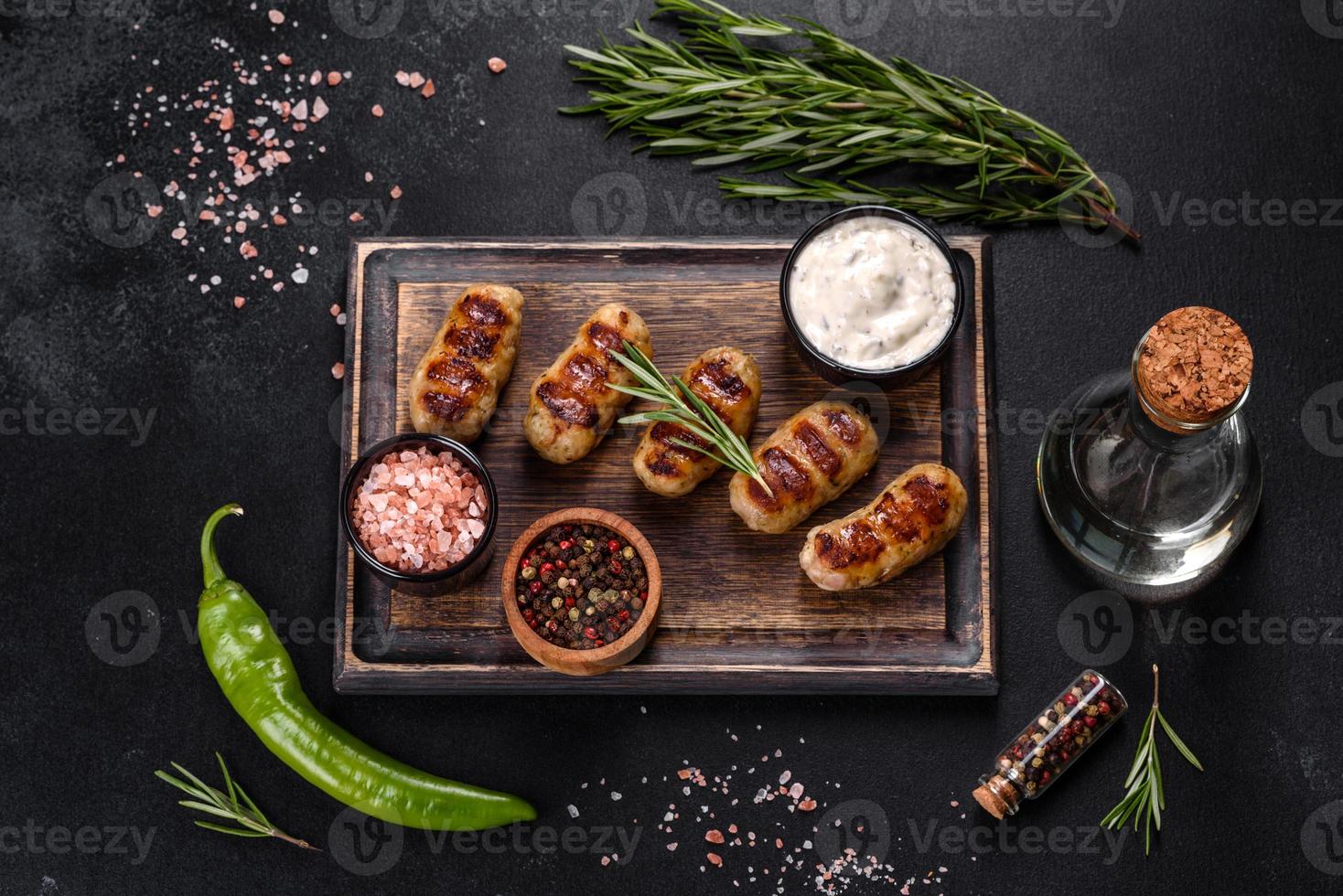 Grilled sausage with the addition of herbs and vegetables photo